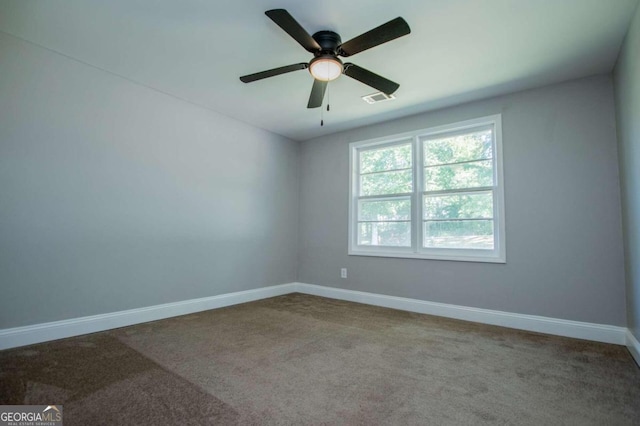 carpeted empty room featuring ceiling fan