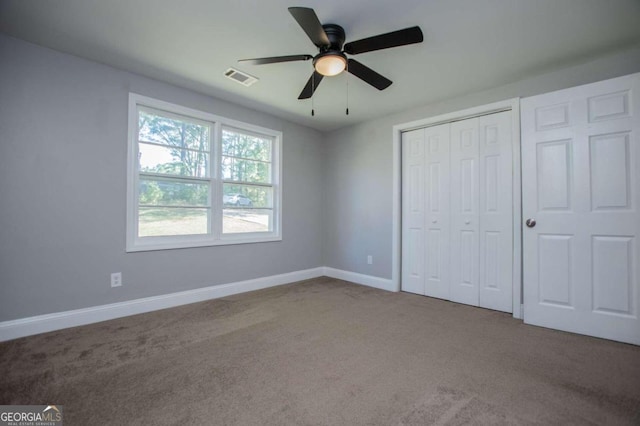 unfurnished bedroom featuring a closet, ceiling fan, and carpet flooring