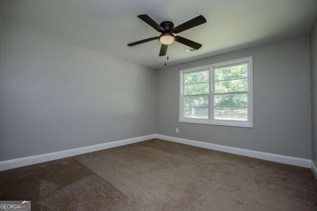 carpeted empty room featuring ceiling fan