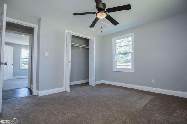 unfurnished bedroom featuring ceiling fan, a closet, and dark carpet