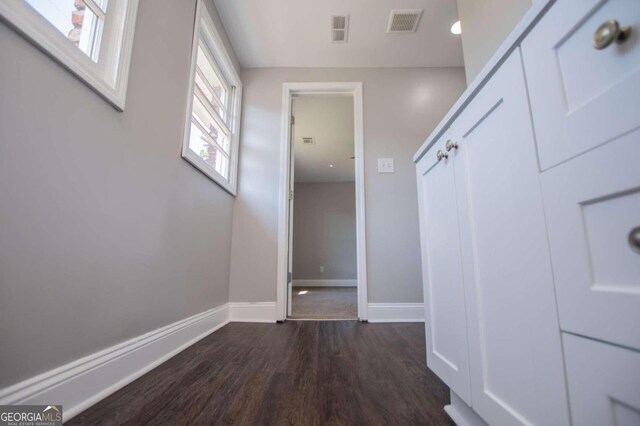 corridor with dark wood-type flooring