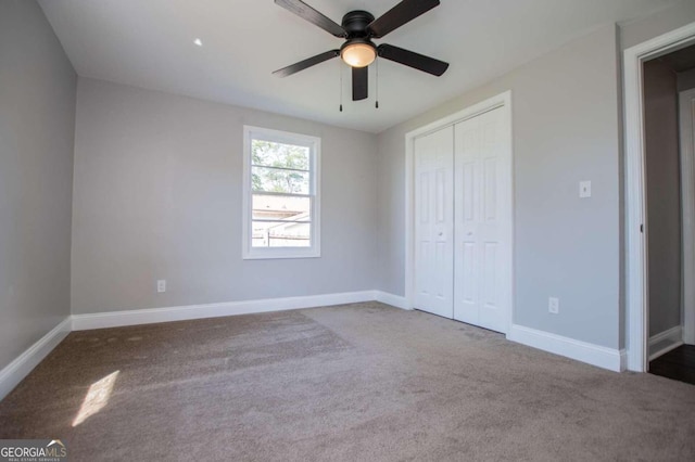 unfurnished bedroom with ceiling fan, carpet floors, and a closet