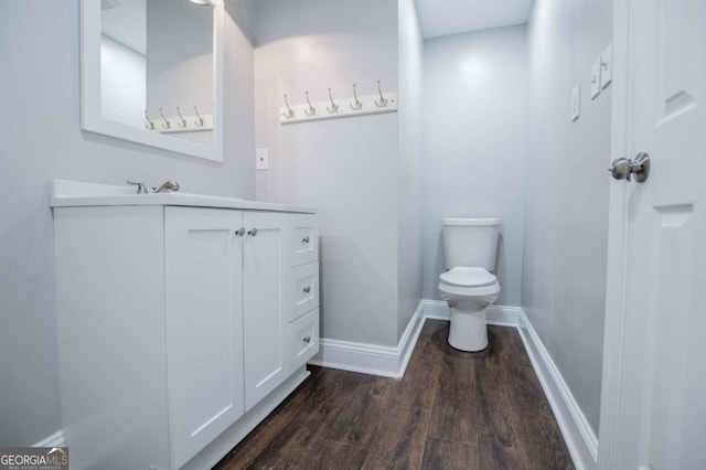 bathroom featuring vanity, hardwood / wood-style floors, and toilet