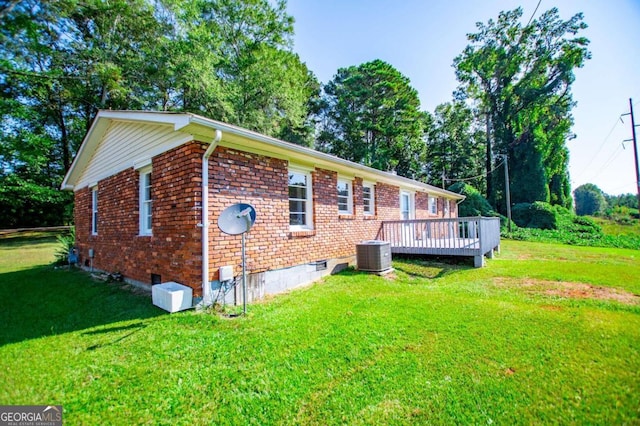 exterior space featuring a wooden deck, central AC unit, and a yard