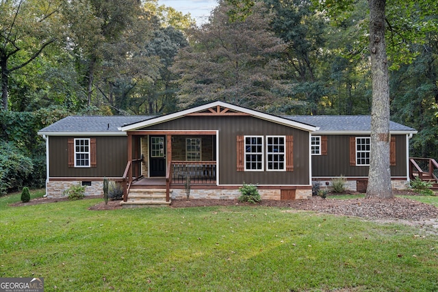 manufactured / mobile home with a porch and a front yard