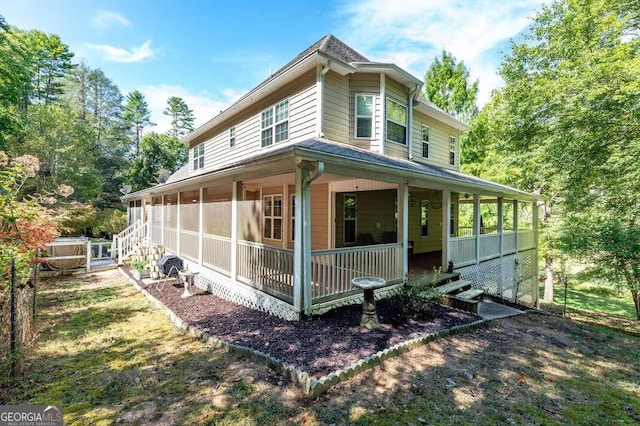 view of side of home featuring a sunroom and a porch