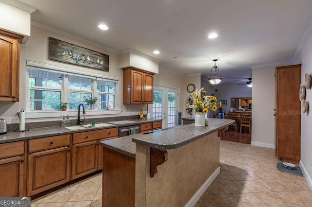 kitchen with sink, crown molding, and a center island