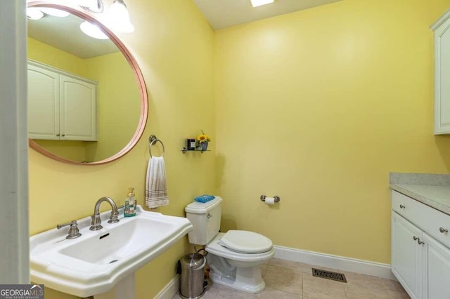 bathroom with tile patterned floors, sink, and toilet