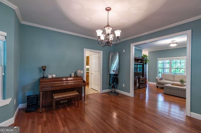 misc room featuring wood-type flooring, a chandelier, and ornamental molding