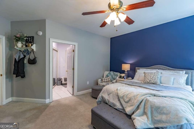 carpeted bedroom featuring ensuite bath and ceiling fan