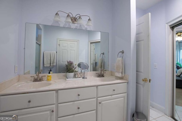 bathroom featuring an enclosed shower, tile patterned floors, and vanity