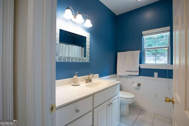 bathroom with tile patterned floors, vanity, and toilet