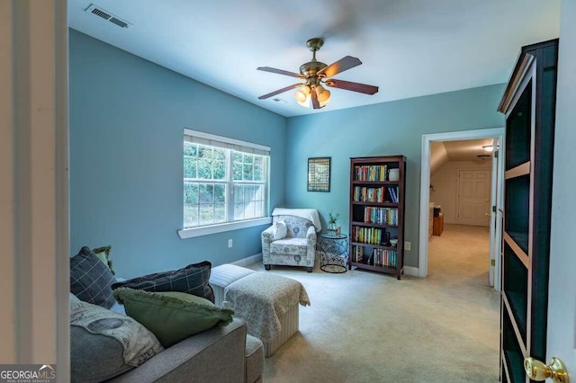 sitting room featuring ceiling fan and light colored carpet