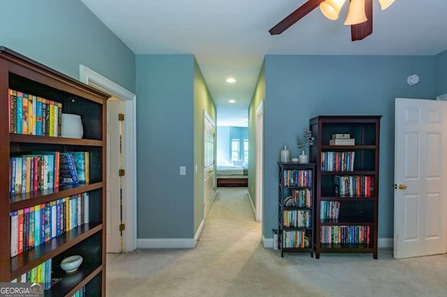 hall with light colored carpet