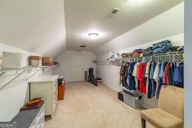 spacious closet with light carpet and vaulted ceiling