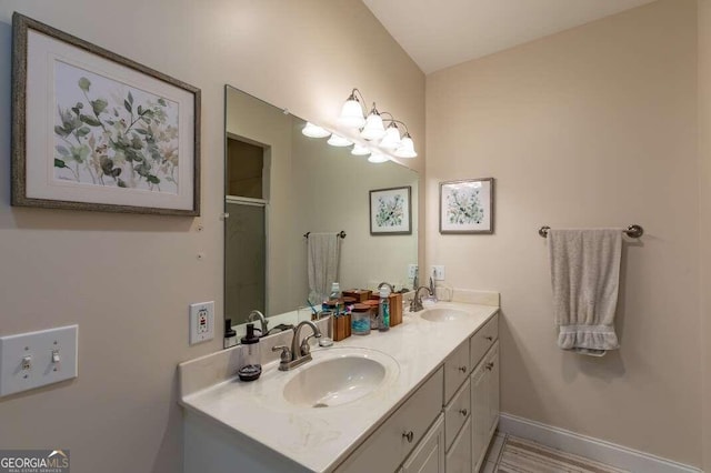 bathroom featuring walk in shower and vanity