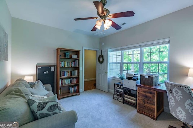 office area with ceiling fan and light carpet