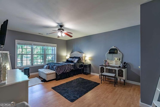 bedroom with ceiling fan and light hardwood / wood-style flooring