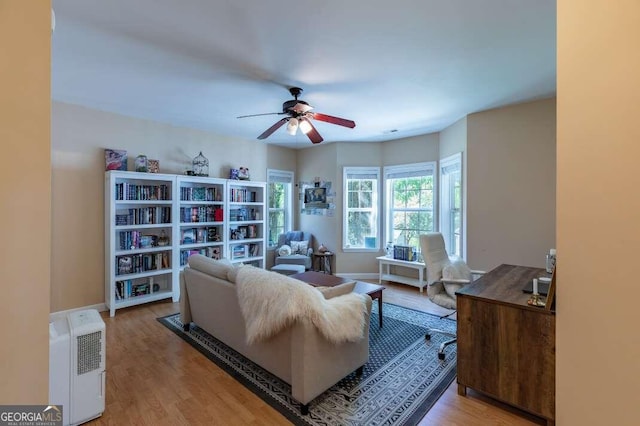 living room featuring ceiling fan and light hardwood / wood-style flooring