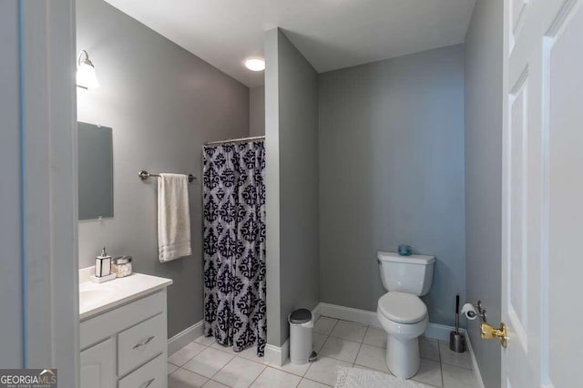 bathroom with vanity, tile patterned flooring, and toilet