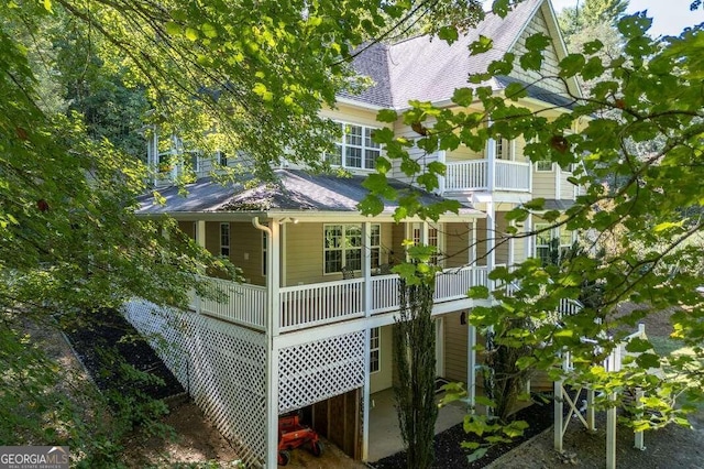 view of side of home featuring a balcony