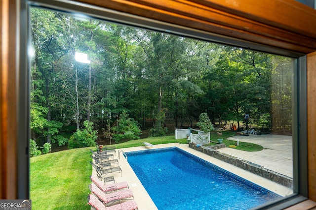 view of swimming pool with a patio and a yard