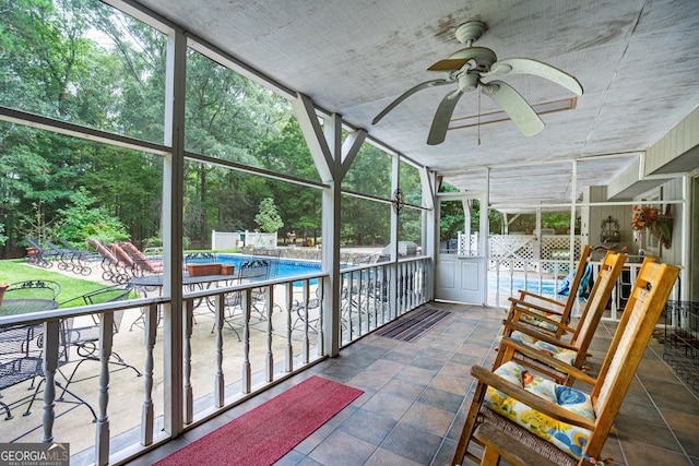 unfurnished sunroom with ceiling fan and plenty of natural light