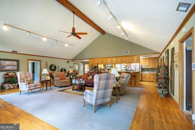 living room with ceiling fan, beam ceiling, high vaulted ceiling, rail lighting, and light wood-type flooring