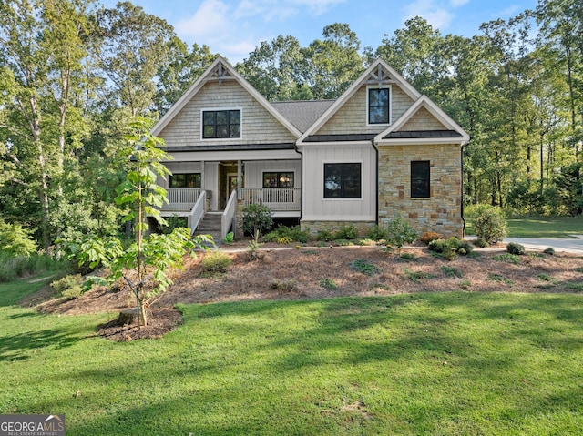 view of front of property with covered porch and a front yard