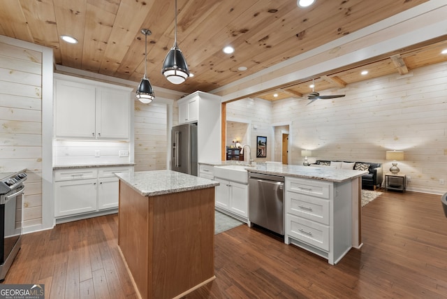 kitchen featuring appliances with stainless steel finishes, white cabinetry, and a kitchen island