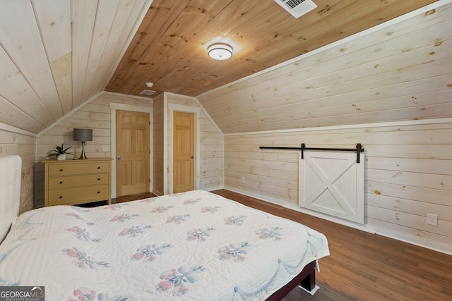 unfurnished bedroom featuring a barn door, wood ceiling, lofted ceiling, and wood walls