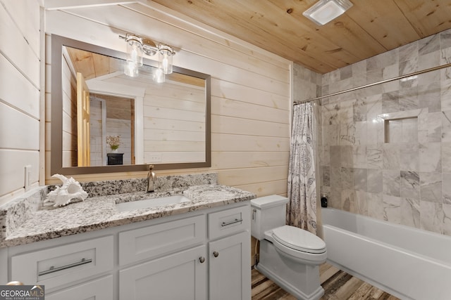 full bathroom with wood walls, vanity, shower / bath combination with curtain, toilet, and hardwood / wood-style floors