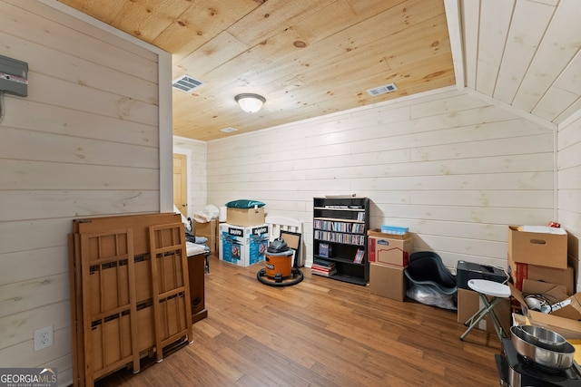 interior space featuring wood-type flooring, lofted ceiling, wooden walls, and wood ceiling