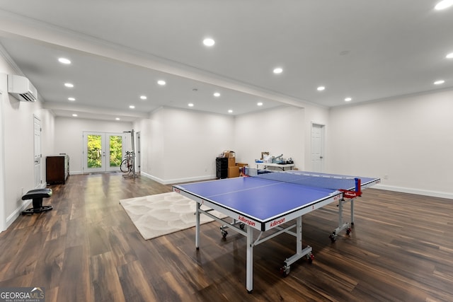 rec room featuring ornamental molding, dark hardwood / wood-style floors, french doors, and a wall mounted AC