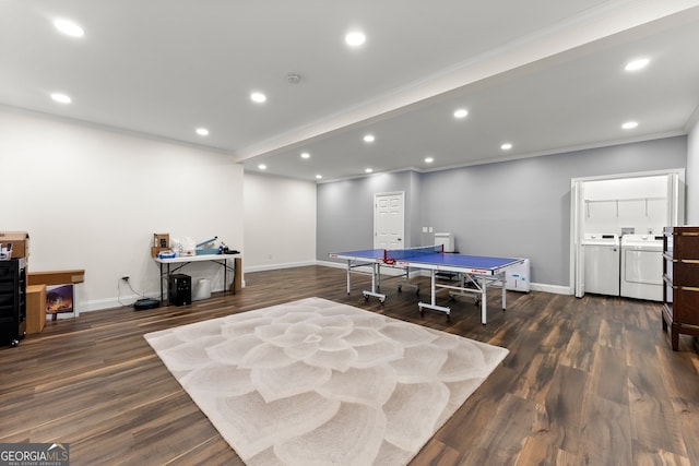 rec room featuring washer and clothes dryer, crown molding, and dark hardwood / wood-style flooring