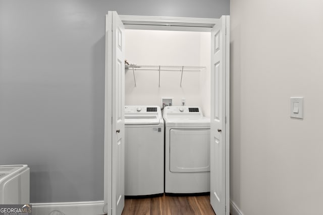 washroom with washer and clothes dryer and dark hardwood / wood-style flooring