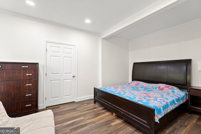 bedroom featuring dark hardwood / wood-style floors and crown molding