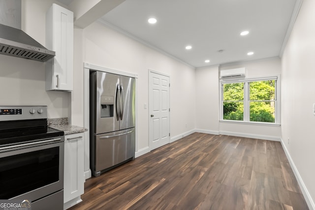 kitchen with white cabinetry, light stone counters, wall chimney exhaust hood, stainless steel appliances, and crown molding