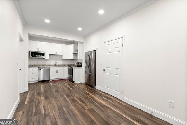 kitchen with sink, white cabinets, stainless steel appliances, dark hardwood / wood-style flooring, and ornamental molding