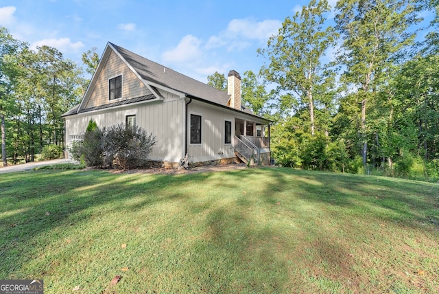 view of side of property with a yard