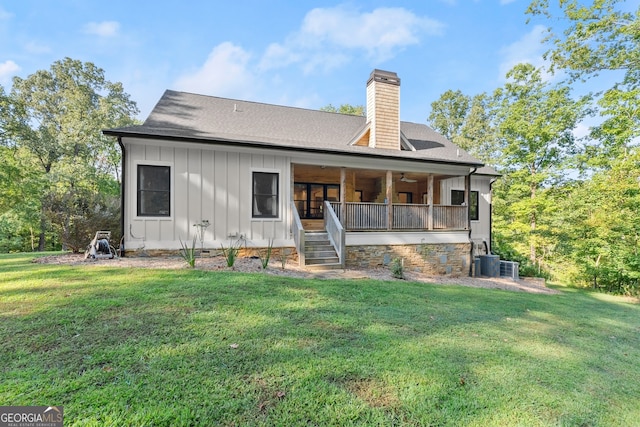 back of house featuring a yard and central AC