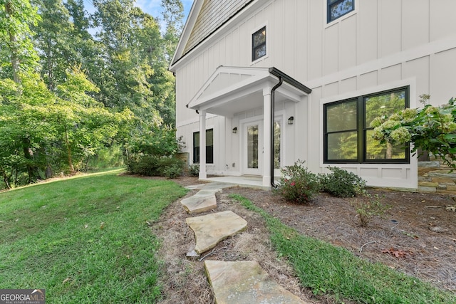 view of exterior entry featuring a yard