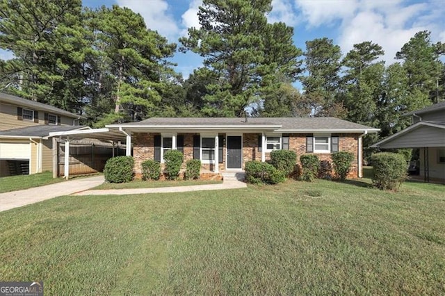 view of front of property with a front yard and a carport