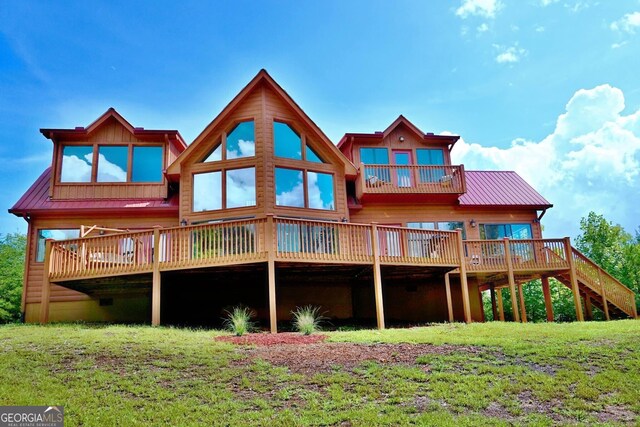 26 Clarice Ln, Sautee Nacoochee, GA 30571 - rear view of property featuring metal roof, a deck, and a lawn