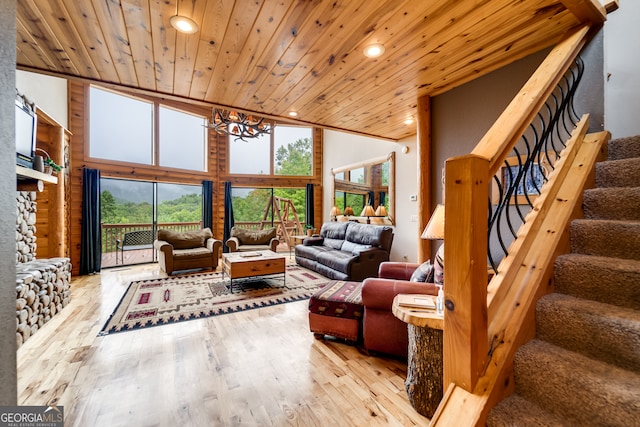 living room with wood ceiling, light hardwood / wood-style floors, high vaulted ceiling, and a notable chandelier