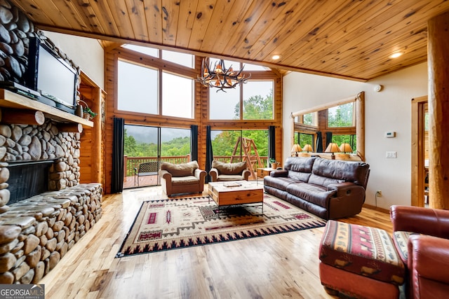 living room with a stone fireplace, light hardwood / wood-style floors, a notable chandelier, and wooden ceiling