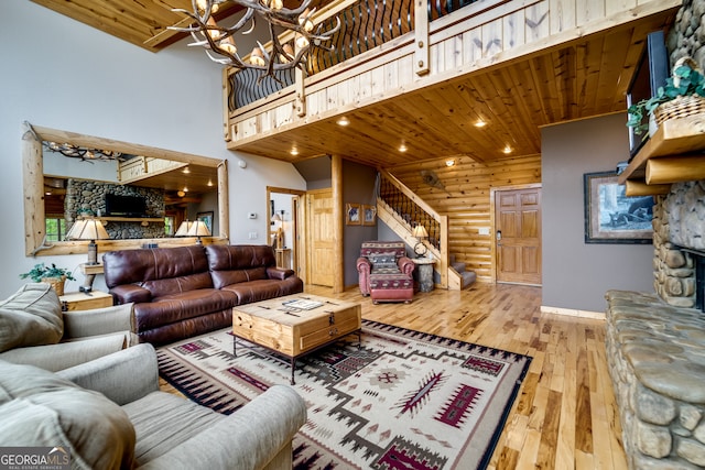 living room with wooden ceiling, a high ceiling, hardwood / wood-style floors, and a chandelier