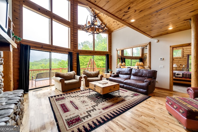 living room featuring an inviting chandelier, wood ceiling, light hardwood / wood-style floors, and high vaulted ceiling