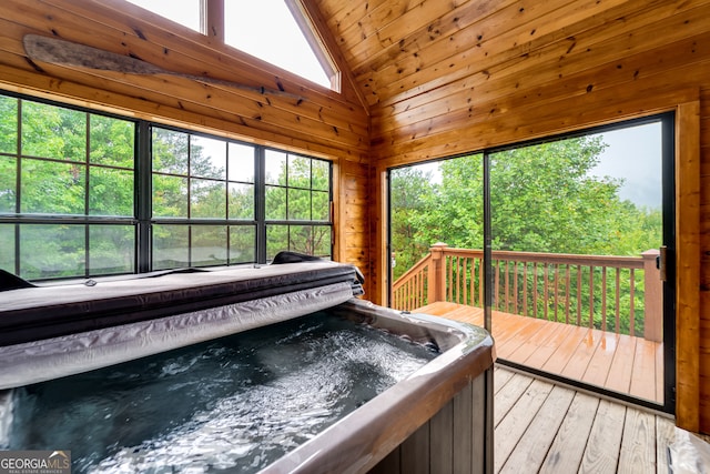 unfurnished sunroom featuring vaulted ceiling, wood ceiling, and a jacuzzi