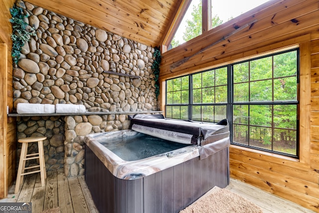 wooden terrace with a hot tub